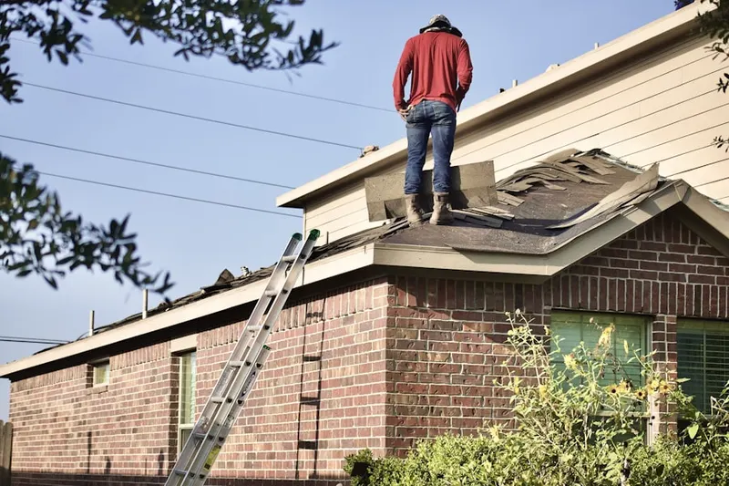 Professional roofer working on a residential roof in Perkerson